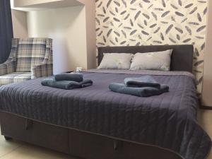 a bed with blue pillows on top of it at Westend Hotel Kyiv in Kyiv