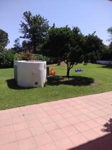 a tub sitting in the grass next to a tree at White Sand Residence in Murta Maria