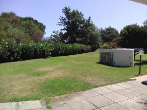 an appliance sitting in the grass in a yard at White Sand Residence in Murta Maria