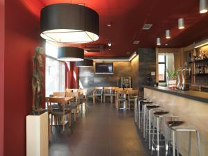 ein Restaurant mit Bar, Tischen und Stühlen in der Unterkunft Hotel Txarriduna in Elgóibar