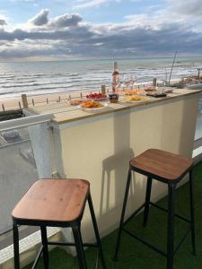 a bar with two stools and a view of the ocean at LACANAU FRONT DE MER in Lacanau