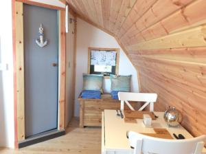 a room in a tiny house with a table and chairs at Achmelvich View self catering in Lochinver