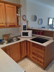 a kitchen with a sink and a microwave at Beachfront Bungalow in Torrox Costa