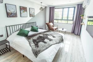 Voodi või voodid majutusasutuse Xiamen Guiran Hostel toas