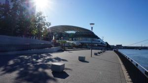 a large building next to a river with a bridge at LuPartment in Ludwigshafen am Rhein