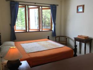 Una cama o camas en una habitación de Sunrise Bungalow