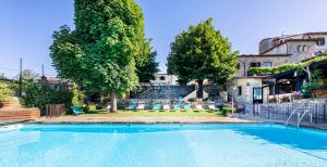 a swimming pool in the backyard of a house at Relais Vignale & Spa in Radda in Chianti