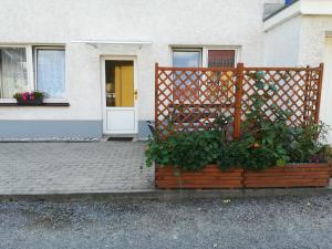 ein Haus mit einem Holzzaun und einigen Pflanzen in der Unterkunft Ferienwohnung Schumann in Bad Schandau
