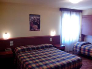 Postel nebo postele na pokoji v ubytování Hotel Monte Fior