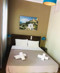 a bedroom with a bed with two towels on it at Kymata in Palaiopoli