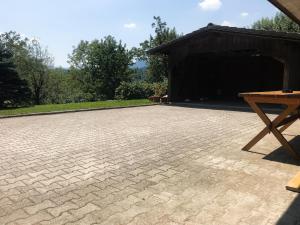 a brick patio with a picnic table in front of a building at Apartment Tosca near Vintgar and Lake Bled in Zgornje Gorje