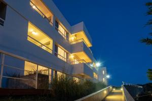 an apartment building at night with lights on at Valeria Playa Apart in Valeria del Mar