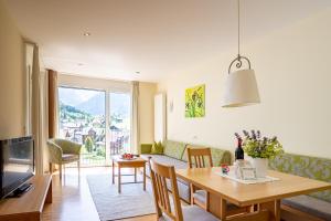 a living room with a table and a couch at Allegra Wohlfühl Appartements in Brand