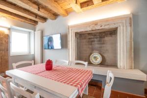 a dining room with a table and a brick fireplace at Bossema Luxury Countryhouse in Cavaion Veronese