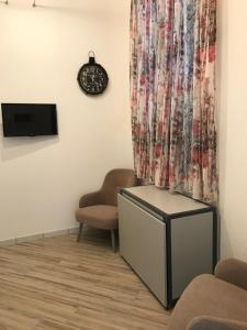 a waiting room with a tv and a curtain at LA DIMORA SICILIANA APPARTAMENTI in Trapani
