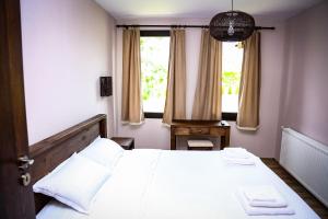 a bedroom with a large bed and a window at Villa Kashtata in Resilovo