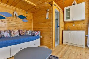 a bedroom with a bed and a table in a cabin at Tramontana Glamping in Bar