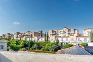 a view of a city with houses and solar panels at Helios Cottages in Paphos City