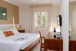 Postel nebo postele na pokoji v ubytování Hotel Michelangelo
