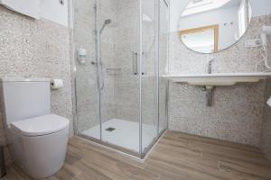 a bathroom with a shower and a toilet and a sink at Ocean Lounge in Altea