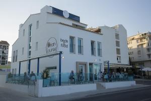 a white building with people sitting outside of it at Ocean Lounge in Altea
