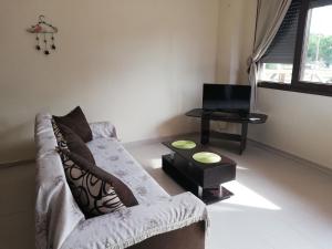 a living room with a couch and a tv at John's Apartments in Nea Michaniona +18 photos