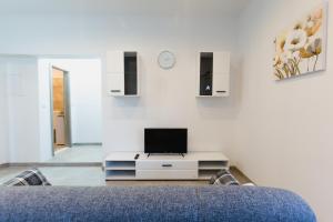 a living room with a tv on a white wall at Putnik in Dugi Rat
