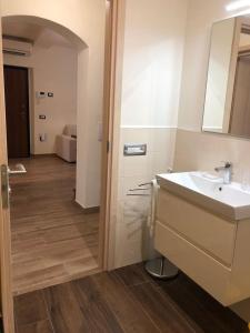 a bathroom with a sink and a mirror at Daniele Guest Apartment in Pistoia