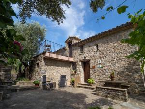 an external view of a stone house with a balcony at Casa Trallero in Almazorre