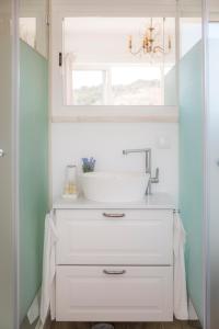 a bathroom with a sink and a mirror at Casa Luisandra Boutique Hotel B&B in Luz