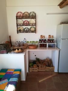 a kitchen with a counter and a refrigerator at Quinta do Maranhão in Lagos