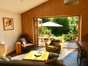 a living room with a couch and chairs and a table at Climbers Cottage in Rosedale Abbey