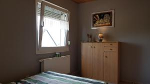 a bedroom with a bed and a window and a dresser at Kansteinblick Weserbergland in Salzhemmendorf +35 photos