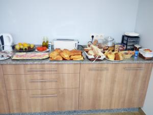 a kitchen counter with bread and other foods on it at Hostal O Pincho in Ponte Do Porto