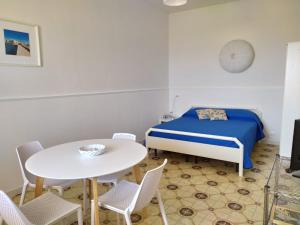 ドンナルカータにあるDonnalucata Roomのベッドルーム1室(ベッド1台、テーブル、椅子付)