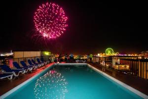 a swimming pool with fireworks on the roof of a hotel at Premiere Motel in Wildwood