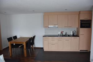 a kitchen with a wooden table and a dining room at Panoramachalet in Agettes