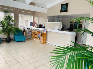 a lobby of a store with a counter and palm trees at Cabana Motel in Ocean City