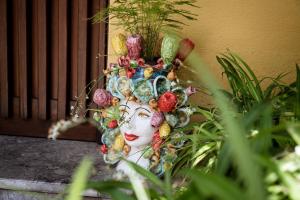 a statue of a woman with vegetables on her head at Lirma B&B in Cefalù