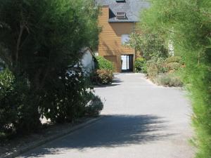 an empty driveway in front of a house with trees at LES BERNACHES in Le Crotoy +40 photos