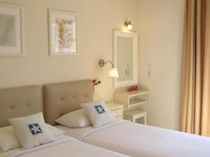 A bed or beds in a room at Alexandris Hotel