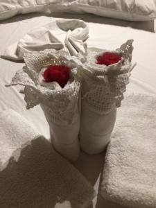 two white vases sitting on top of a bed at Adams Studio in Oropos in Oropos