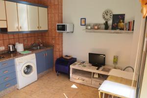 サン・セバスティアン・デ・ラ・ゴメラにあるBalcón al Atlánticoのキッチン(洗濯機、デスク、テレビ付)