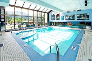 a swimming pool with a swimming pool table and chairs at Best Western Plus Siding 29 Lodge in Banff