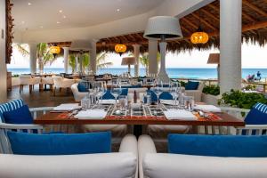 a dining room with a table and chairs and the ocean at Mar del Cabo By Velas Resorts in San José del Cabo