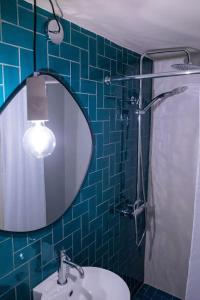 a bathroom with a mirror and a sink and a shower at Anna Maria's, cozy studio in the heart of Fiscardo in Fiskardho