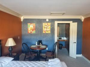 a room with a bed and a table and chairs at Lily Pad Suites in Andrews