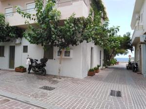 a street with two motorcycles parked next to a building at Odyssey Apartment in Palaiochora