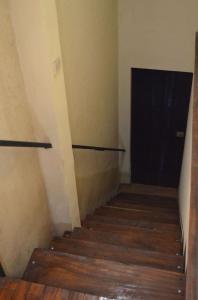 a staircase with a black door and a wooden floor at #5 Private room close to Airport in Alajuela City