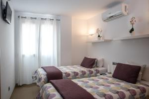 Postel nebo postele na pokoji v ubytování Apartaments Delfin
